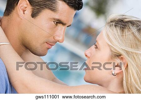 Side profile of a young woman embracing a mid adult man View Large Photo Image Stock Image - Side profile of a young woman embracing a mid adult man. Fotosearch
