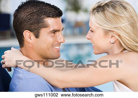 Side profile of a young woman embracing a mid adult man View Large Photo Image Stock Image - Side profile of a young woman embracing a mid adult man. Fotosearch