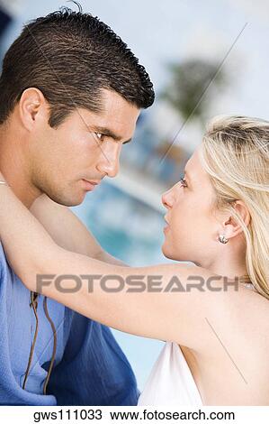 Side profile of a young woman embracing a mid adult man View Large Photo Image Stock Image - Side profile of a young woman embracing a mid adult man. Fotosearch