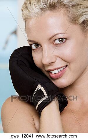 Close-up of a young woman wearing boxing gloves View Large Photo Image Stock Image - Close-up of a young woman wearing boxing gloves. Fotosearch