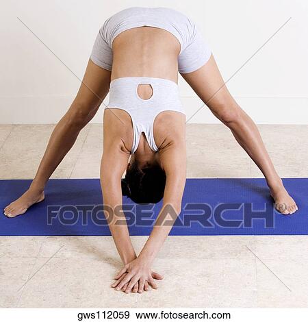 High angle view of a young woman performing yoga View Large Photo Image Stock Photo - High angle view of a young woman performing yoga. Fotosearch
