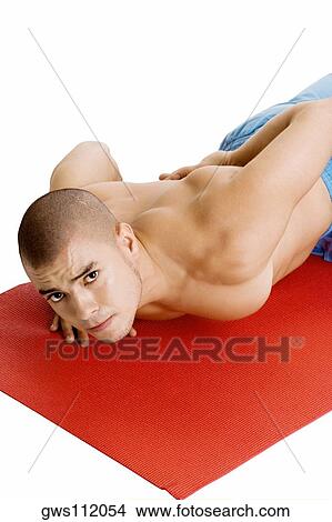 Portrait of a young man doing push-ups on an exercise mat View Large Photo Image Picture - Portrait of a young man doing push-ups on an exercise mat. Fotosearch