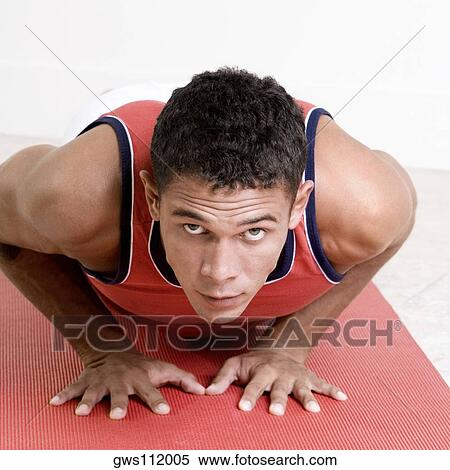 Portrait of a young man doing push-ups on an exercise mat View Large Photo Image Stock Photography - Portrait of a young man doing push-ups on an exercise mat. Fotosearch