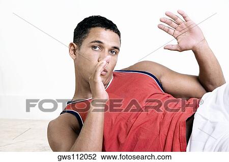 Stock Image - Portrait of a young man exercising. Fotosearch