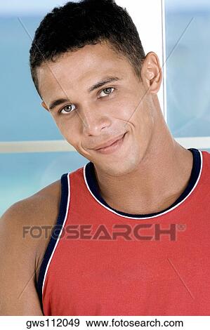 Portrait of a young man smiling View Large Photo Image Stock Photo - Portrait of a young man smiling. Fotosearch