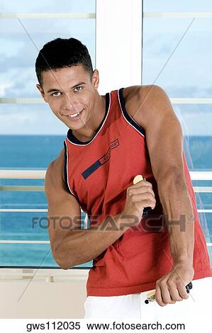 Portrait of a young man squeezing a hand grip View Large Photo Image Stock Photography - Portrait of a young man squeezing a hand grip. Fotosearch
