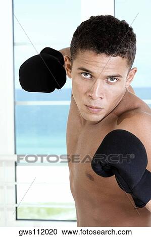 Portrait of a young man wearing boxing gloves View Large Photo Image Stock Image - Portrait of a young man wearing boxing gloves. Fotosearch