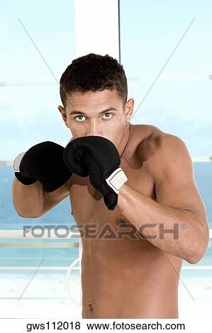 Portrait of a young man wearing boxing gloves View Large Photo Image Stock Photo - Portrait of a young man wearing boxing gloves. Fotosearch