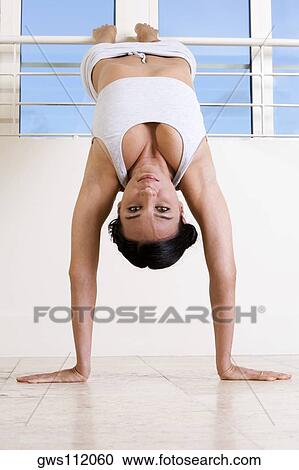 Portrait of a young woman exercising View Large Photo Image Stock Image - Portrait of a young woman exercising. Fotosearch