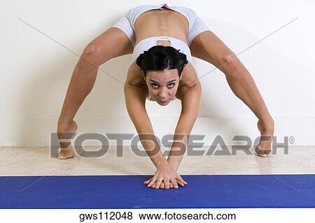 Portrait of a young woman exercising View Large Photo Image Stock Photo - Portrait of a young woman exercising. Fotosearch