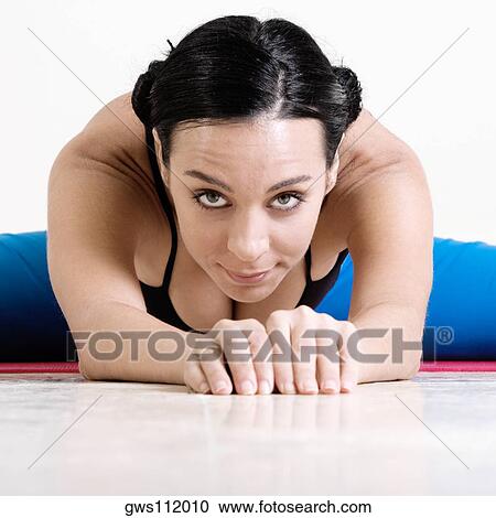 Portrait of a young woman performing yoga View Large Photo Image Stock Image - Portrait of a young woman performing yoga. Fotosearch