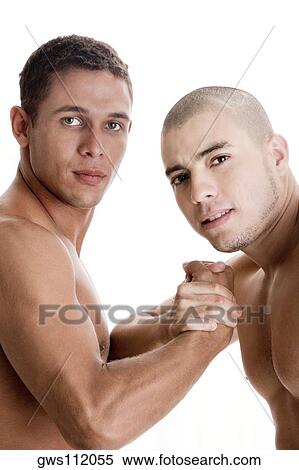 Stock Photography - Portrait of two young men holding hands. Fotosearch
