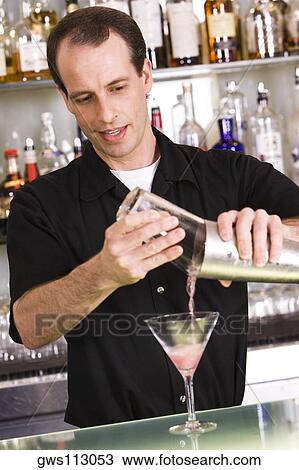 Bartender preparing a martini View Large Photo Image Stock Image - Bartender preparing a martini. Fotosearch