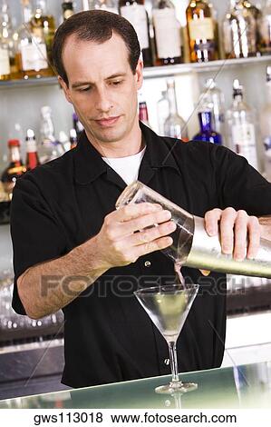 Bartender preparing a martini View Large Photo Image Stock Photo - Bartender preparing a martini. Fotosearch