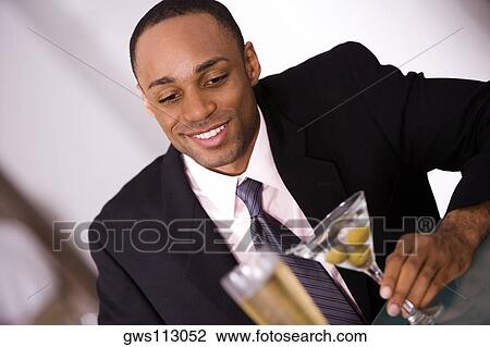 Close-up of a businessman holding a glass of wine View Large Photo Image Stock Image - Close-up of a businessman holding a glass of wine. Fotosearch