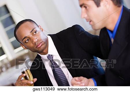 Close-up of a businessman holding a glass of wine View Large Photo Image Stock Photo - Close-up of a businessman holding a glass of wine. Fotosearch