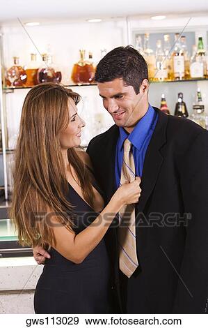 Mid adult couple looking at each other and smiling in a bar View Large Photo Image Stock Photo - Mid adult couple looking at each other and smiling in a bar. Fotosearch
