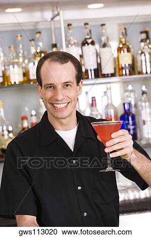 Portrait of a mid adult man holding a cocktail View Large Photo Image Stock Image - Portrait of a mid adult man holding a cocktail. Fotosearch