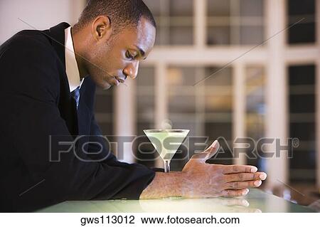 Side profile of a businessman with a glass of martini View Large Photo Image Stock Image - Side profile of a businessman with a glass of martini. Fotosearch