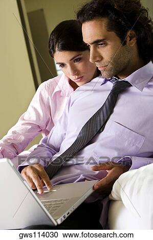 Businessman and a businesswoman in front of a laptop View Large Photo Image Stock Image - Businessman and a businesswoman in front of a laptop. Fotosearch