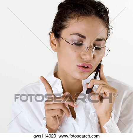 Stock Image - Close-up of a young woman talking on a mobile phone. Fotosearch