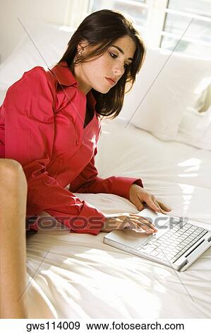 High angle view of a businesswoman using a laptop View Large Photo Image Stock Photo - High angle view of a businesswoman using a laptop. Fotosearch