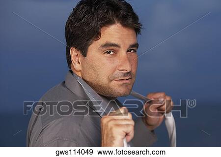 Portrait of a businessman holding his tie View Large Photo Image Stock Photo - Portrait of a businessman holding his tie. Fotosearch