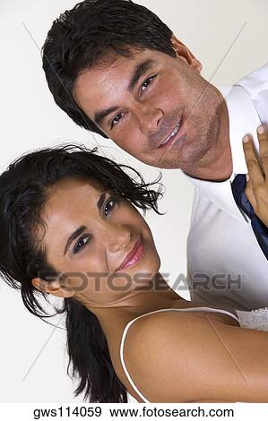 Portrait of a young woman and a mid adult man smiling View Large Photo Image Stock Photo - Portrait of a young woman and a mid adult man smiling. Fotosearch