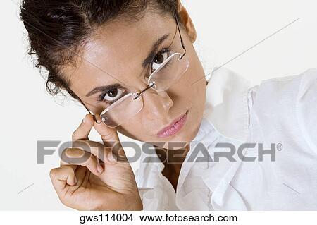 Portrait of a young woman wearing eyeglasses View Large Photo Image Picture - Portrait of a young woman wearing eyeglasses. Fotosearch