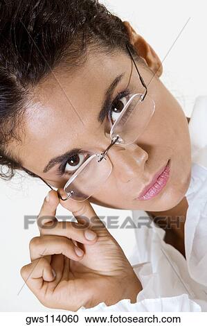 Portrait of a young woman wearing eyeglasses View Large Photo Image Stock Image - Portrait of a young woman wearing eyeglasses. Fotosearch