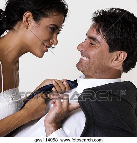 Side profile of a young woman and a mid adult man smiling View Large Photo Image Stock Photo - Side profile of a young woman and a mid adult man smiling. Fotosearch