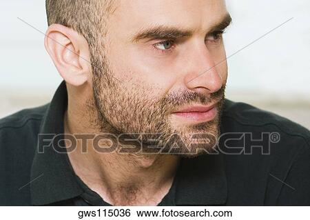 Stock Photograph - Close-up of a mid adult man looking sideways. Fotosearch