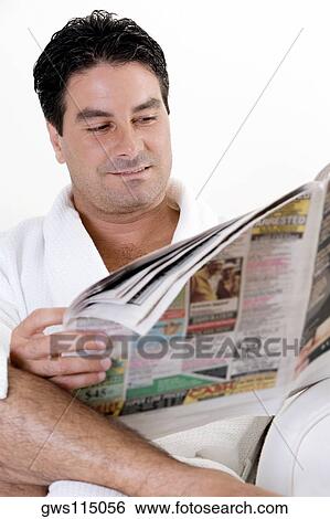 Stock Photograph - Close-up of a mid adult man reading a newspaper. Fotosearch