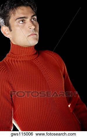 Low angle view of a young man looking serious View Large Photo Image Stock Photograph - Low angle view of a young man looking serious. Fotosearch