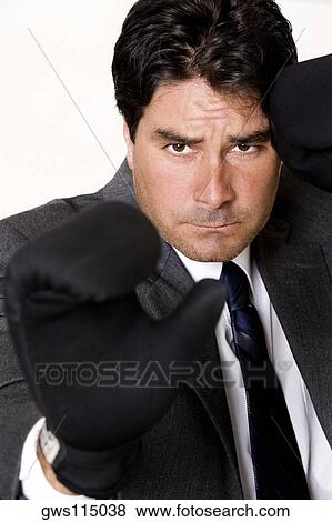 Portrait of a businessman wearing boxing gloves View Large Photo Image Stock Photo - Portrait of a businessman wearing boxing gloves. Fotosearch