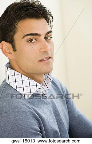 Stock Image - Portrait of a mid adult man leaning against a wall. Fotosearch
