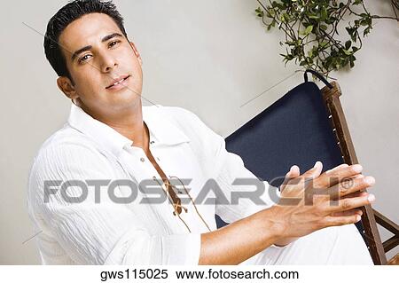 Portrait of a mid adult man sitting View Large Photo Image Stock Photography - Portrait of a mid adult man sitting. Fotosearch