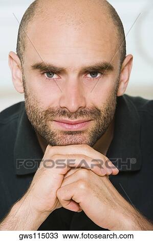 Portrait of a mid adult man with his hands under his chin View Large Photo Image Stock Image - Portrait of a mid adult man with his hands under his chin. Fotosearch