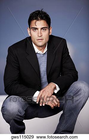 Portrait of a young man crouching View Large Photo Image Stock Photo - Portrait of a young man crouching. Fotosearch