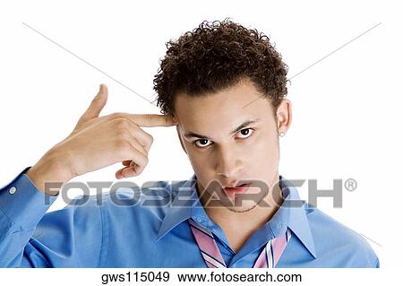 Portrait of a young man making a gun sign View Large Photo Image Stock Photo - Portrait of a young man making a gun sign. Fotosearch