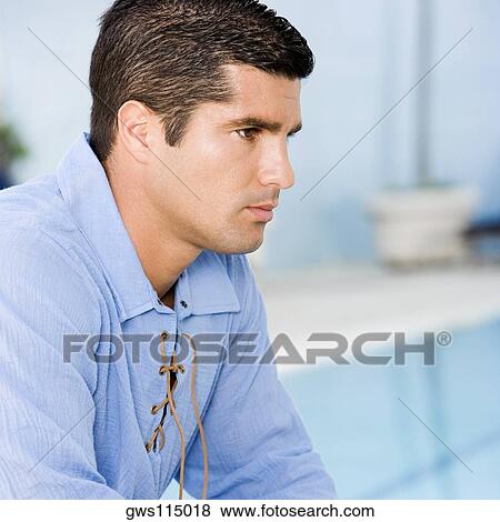 Stock Photo - Side profile of a mid adult man looking serious. Fotosearch