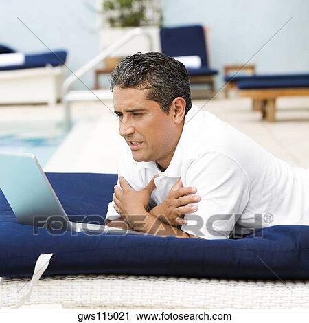 Side profile of a mid adult man using a laptop View Large Photo Image Stock Image - Side profile of a mid adult man using a laptop. Fotosearch