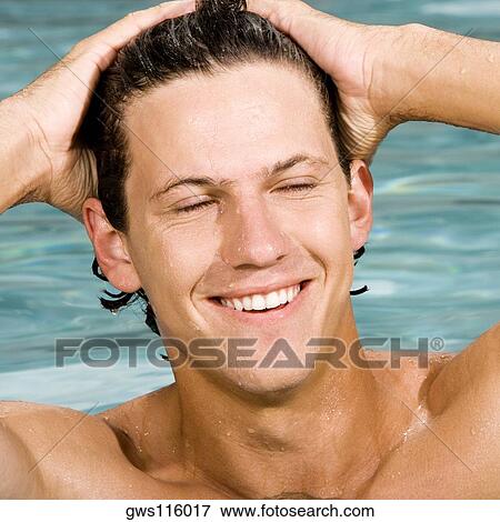 Close-up of a young man smiling View Large Photo Image Stock Photo - Close-up of a young man smiling. Fotosearch