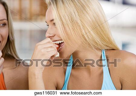Close-up of a young woman eating a strawberry View Large Photo Image Stock Image - Close-up of a young woman eating a strawberry. Fotosearch
