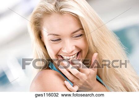 Close-up of a young woman smiling View Large Photo Image Stock Image - Close-up of a young woman smiling. Fotosearch