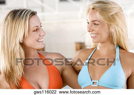 Close-up of two young women smiling View Large Photo Image Stock Image - Close-up of two young women smiling. Fotosearch