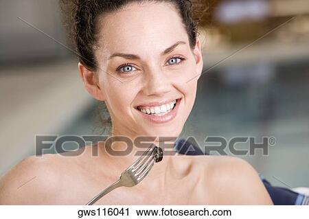 Portrait of a young woman holding a fork with an olive View Large Photo Image Stock Image - Portrait of a young woman holding a fork with an olive. Fotosearch