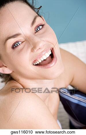 Stock Image - Portrait of a young woman laughing. Fotosearch