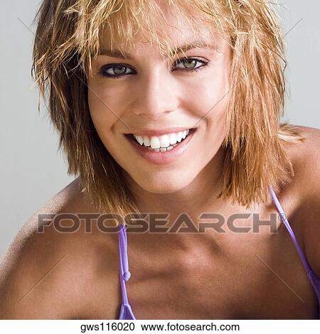 Stock Image - Portrait of a young woman smiling. Fotosearch
