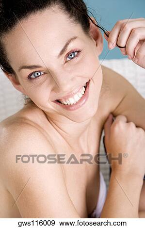 Portrait of a young woman smiling View Large Photo Image Stock Photo - Portrait of a young woman smiling. Fotosearch